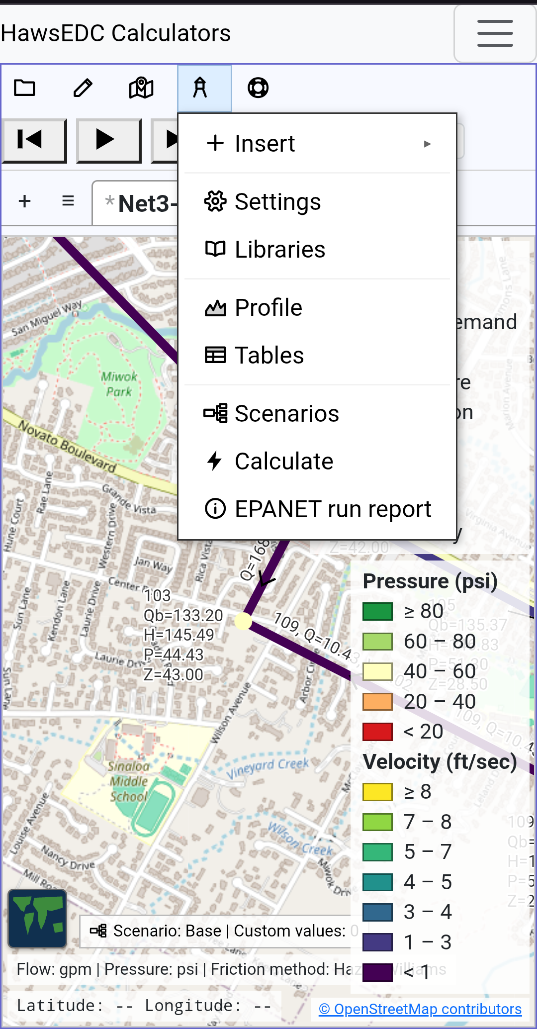 The software on a phone held upright: a menu open beneath its button, a water network drawn on satellite imagery, a flow color key at the right, and a status line along the bottom.